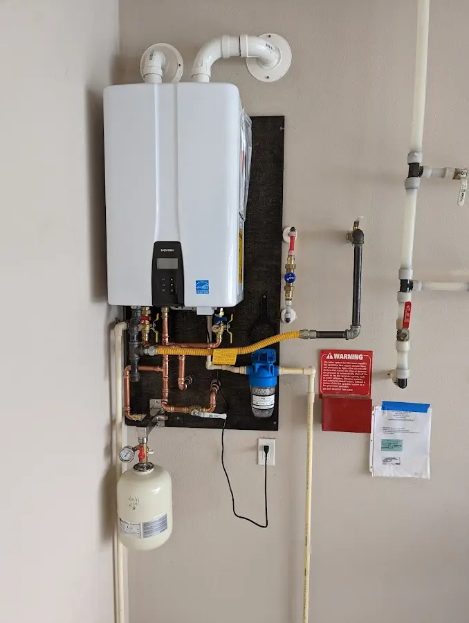 Professional plumber installing copper piping in a Warrenville home